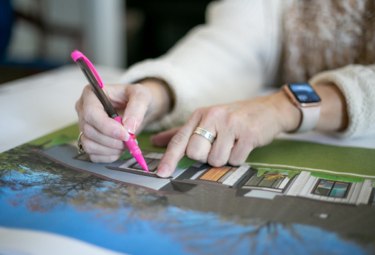 Designer pointing out designs in plan